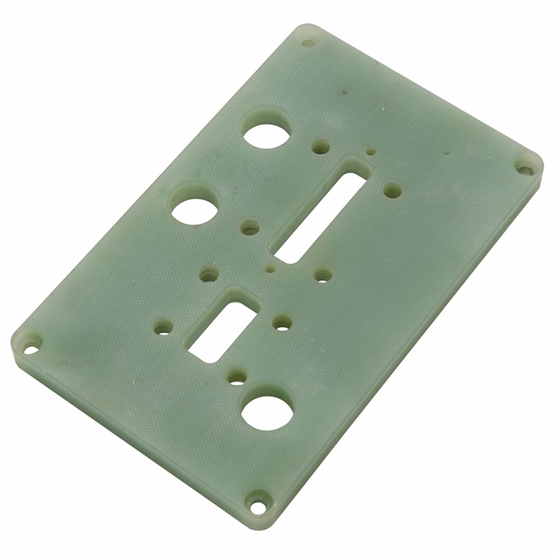 Custom CNC machined green FR4 test fixture plate with probe guide holes and clearance slots